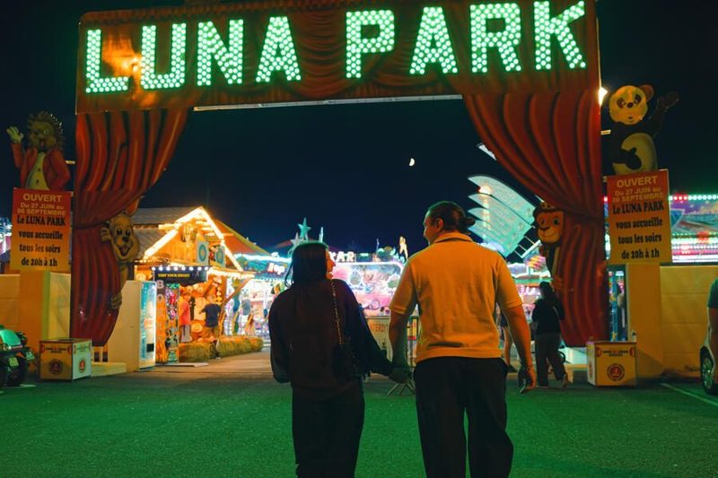 Luna Park van Argelès-sur-Mer bij nacht: verlicht reuzenrad, achtbanen en rijen attracties