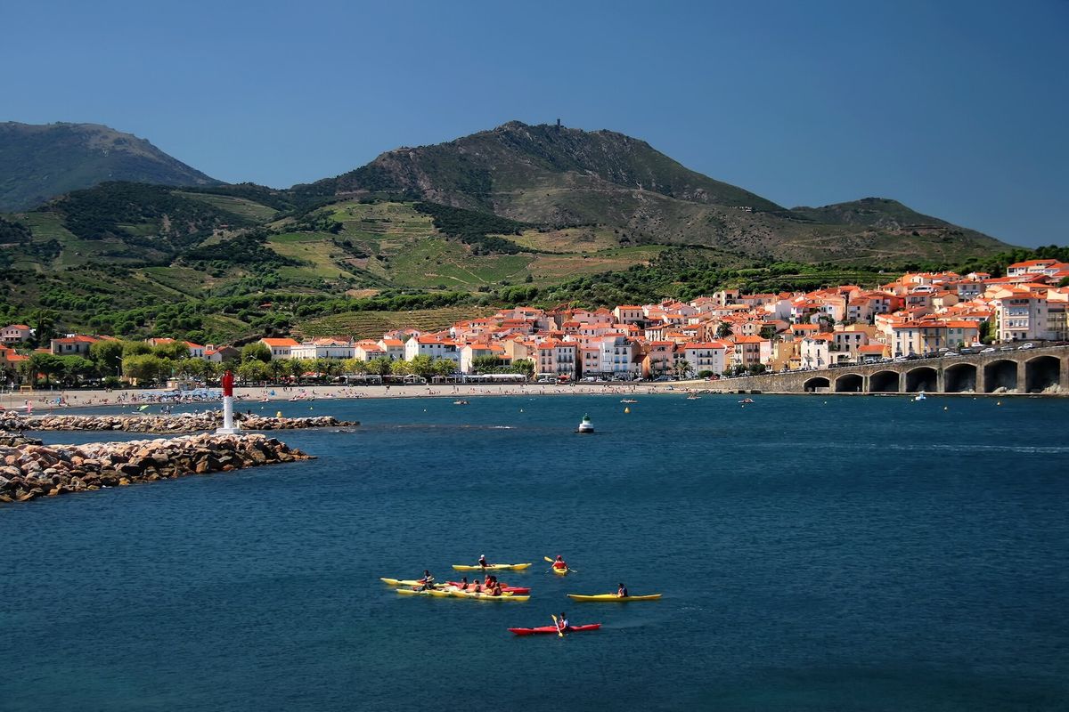 The bay of Banyuls-sur-Mer, the village and the vine-covered hills, kayaks on the water