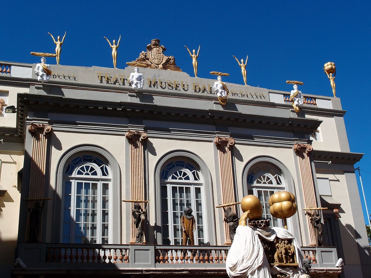 Facade of the Dalí Theatre-Museum in Figueres, topped with golden statues