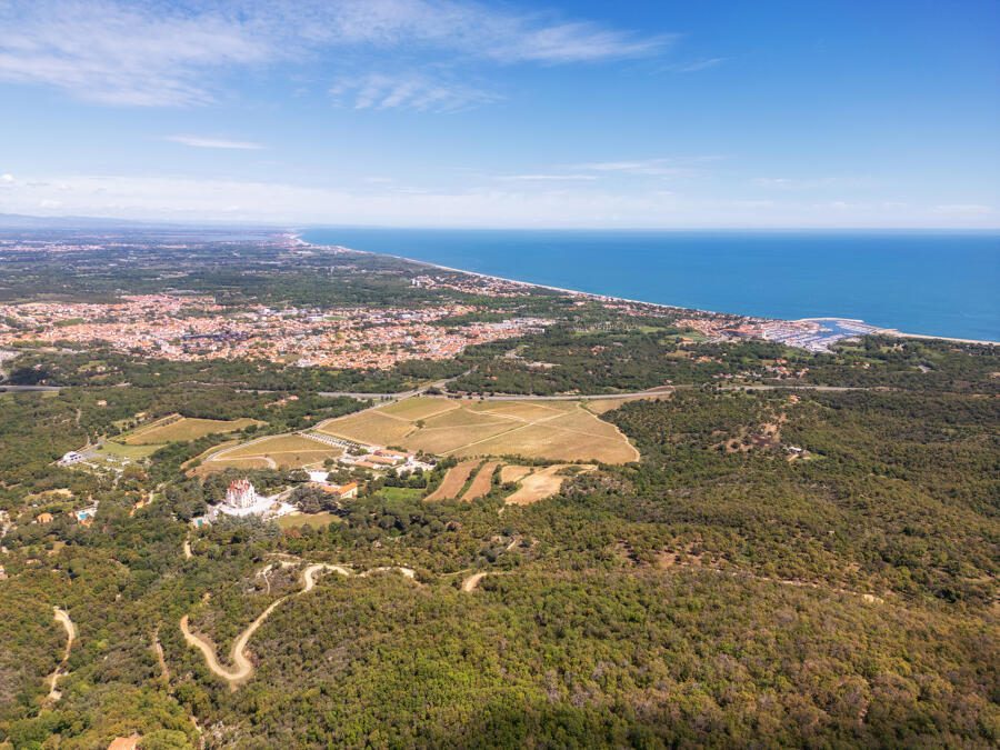 Aerial view of Argelès-sur-Mer between the Mediterranean Sea and the wooded foothills of the Albères